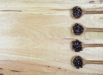 coffee beans and wooden spoon on the table background