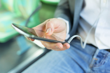 Man using his cell phone. listen music . At bus. texting  message