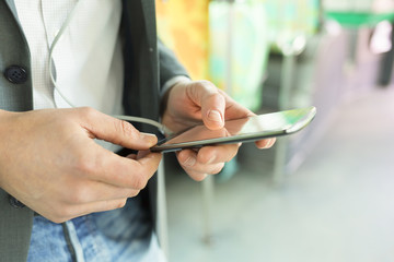Man using his cell phone. listen music . At bus. texting message