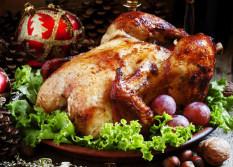 Christmas roast turkey or chicken decorated with nuts, fir cones