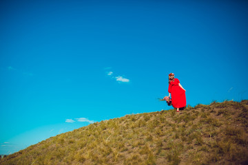 Girl in the Red Dress is Walking on the Field