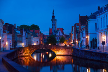 Peaceful cityscape at night from canal in Bruges