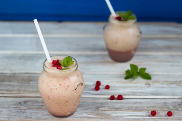 Fruit smoothie with mint leaves on wooden rustic table