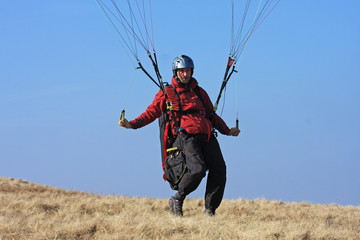 Paraglider landing - obrazy, fototapety, plakaty