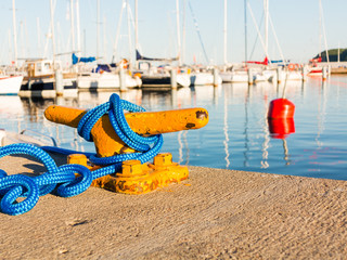 Mooring bollard with rope on pier by the sea