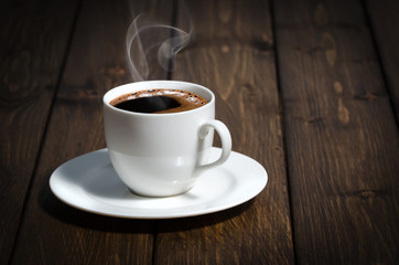 Coffee cup on the wooden table.