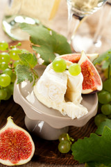 Goat cheese on a stand with fruits