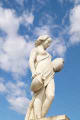 Statue showing a greek mythical muse at blue sky