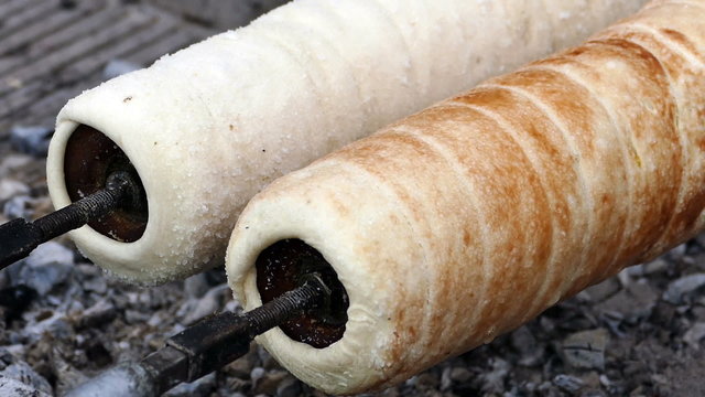 Hungarian Kurtoskalacs prepared on the grill, at a traditional food fair. Specific for Transylvania, Romania.