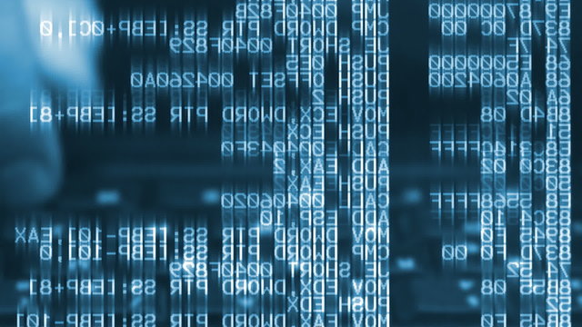 Man typing on keyboard with computer program source code in front - seen from behind the display