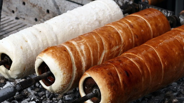Hungarian Kurtoskalacs prepared on the grill, at a traditional food fair. Specific for Transylvania, Romania.