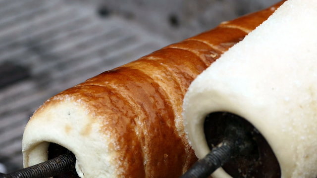 Hungarian Kurtoskalacs prepared on the grill, at a traditional food fair. Specific for Transylvania, Romania.