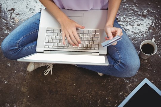 Businesswoman shopping online on laptop