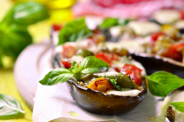 Baked eggplants stuffed with vegetable and mozzarella.