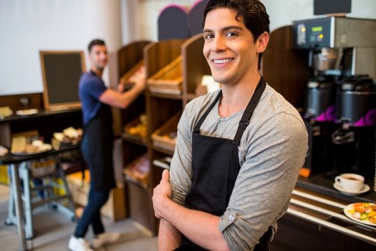 Handsome waiters smiling at camera