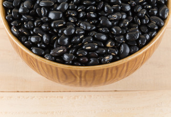 black beans on wood background