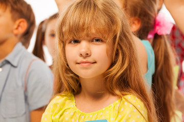 Little girl stand in the large group of friends