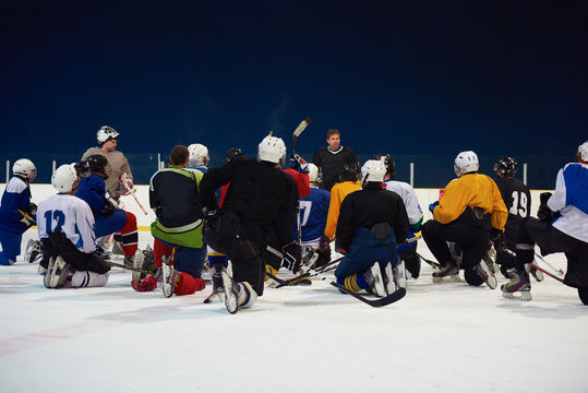 ice hockey players team meeting with trainer