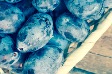 Fresh plums in a basket