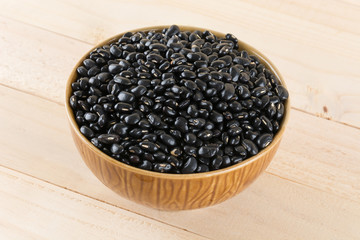 black beans on wood background