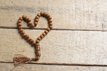 tasbih (moslem prayer beads) at wooden board