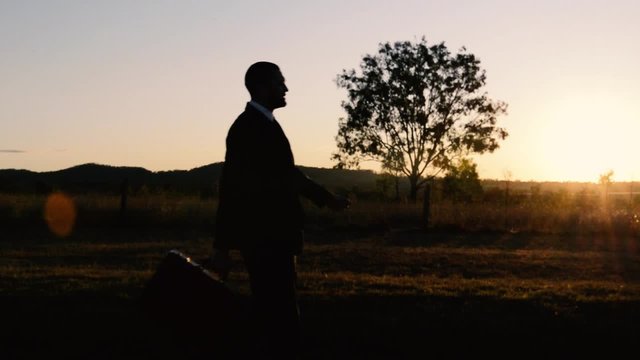 Concept: A frustrated business man is leaving the corporate lifestyle and chasing freedom in the outback of Queensland, Australia. Cinematic Portrait Style.