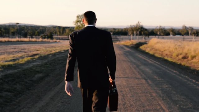 Concept: A frustrated business man is leaving the corporate lifestyle and chasing freedom in the outback of Queensland, Australia. Cinematic Portrait Style.