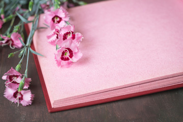 Pink vintage photo album page with flowers
