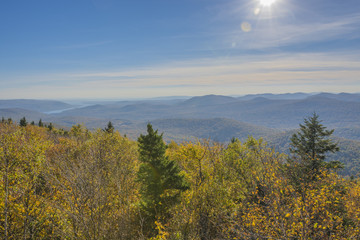 Colorful Autumn view on a sunny day with The Great Sacandaga Lake in the distance.