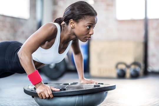 Young woman exercising in gym