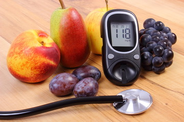 Glucose meter with medical stethoscope and fresh fruits, healthy lifestyle