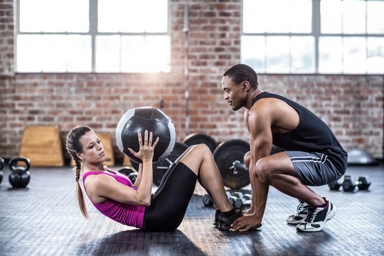 Fit couple doing abdominal ball exercise 
