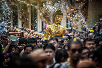 Naklejka premium NONGKHAI THAILAND APRIL 13: Songkran Festival, The people pour water and joined parade of the statue of Luang Pho Phra Sai with respect to faith on April 13, 2011 in Nongkhai Thailand.