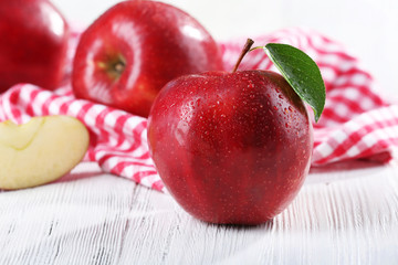 Ripe red apples on table close up