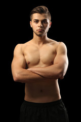 Muscle young man on dark background