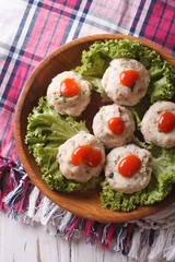 canederli with tomato sauce closeup on a plate. Vertical top view
