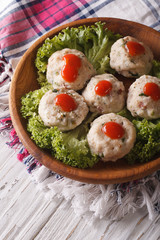 Delicious kanederli with tomato sauce closeup on a plate. vertical
