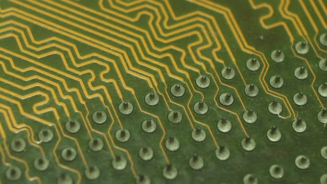 Macro Camera Dolly across diagonal printed circuits:start from soldered circuit 'nipples' then move to circuit cluster; return. 