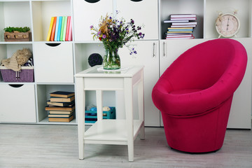 White living room with armchair and bookcase