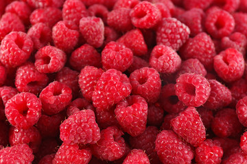 Heap of sweet red raspberries close up