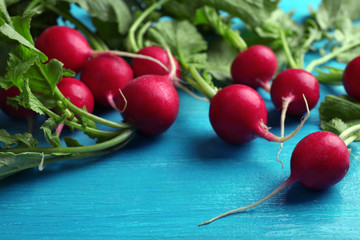 Fresh red radish on color wooden table, closeup