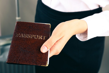 Woman holding passport close up
