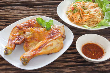grilled chicken with papaya salad,wood background