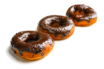 Delicious doughnuts with chocolate icing isolated on white