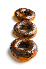 Delicious doughnuts with chocolate icing isolated on white