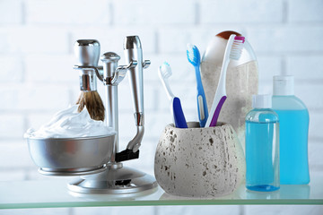 Male luxury shaving kit on shelf, on bricks wall background