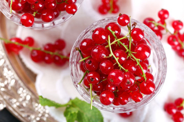 Fresh red currants in glasses close up