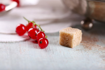 Fresh red currants with sugar on table close up