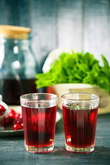Sweet homemade cherry juice on table, on color wooden background