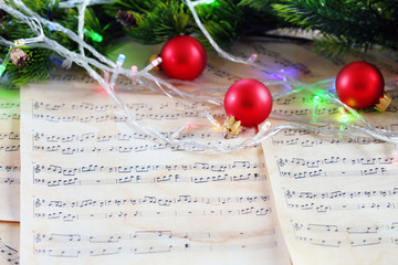 Fototapeta na wymiar Christmas decorations on music sheets, closeup